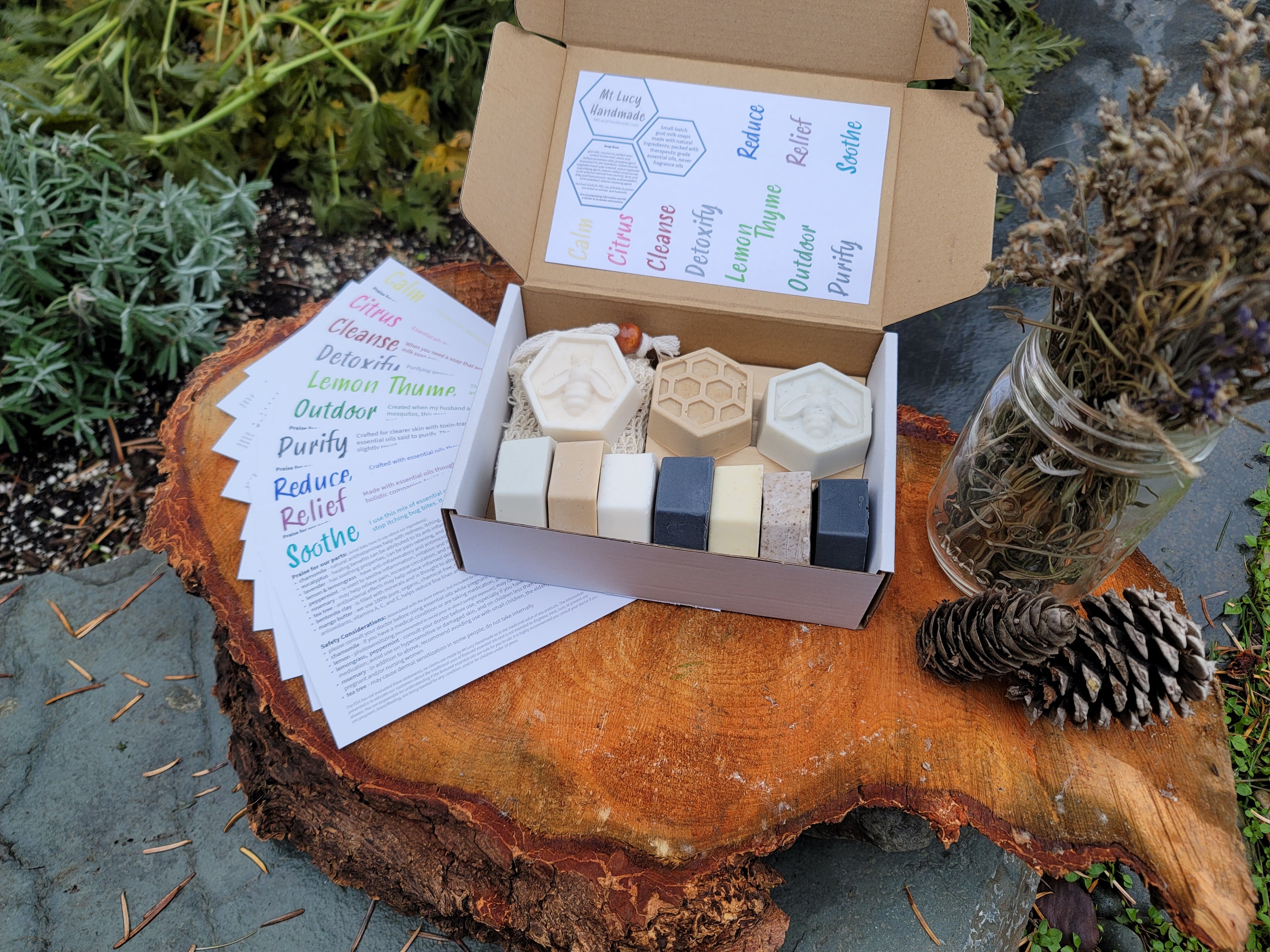 picture of small soap gift box; 10 small soaps artfully arranged in gift box with info cards, sisal soap bag, and soap dish