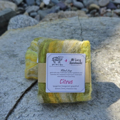 citrus square soap wrapped in yellow and green felt and white label on a slate background