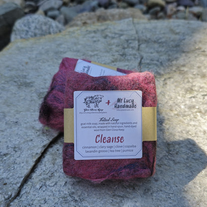 cleanse square soap wrapped in dark pink felt and white label on a slate background