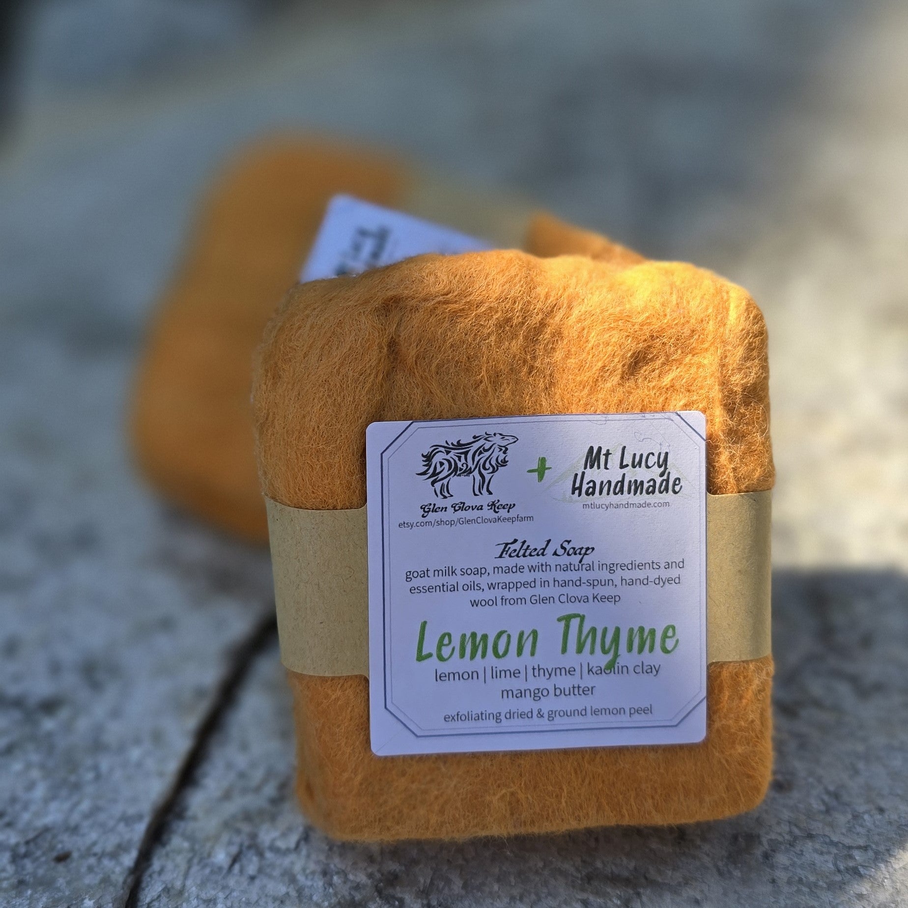 lemon thyme square soap with orange felt and white label on a slate background