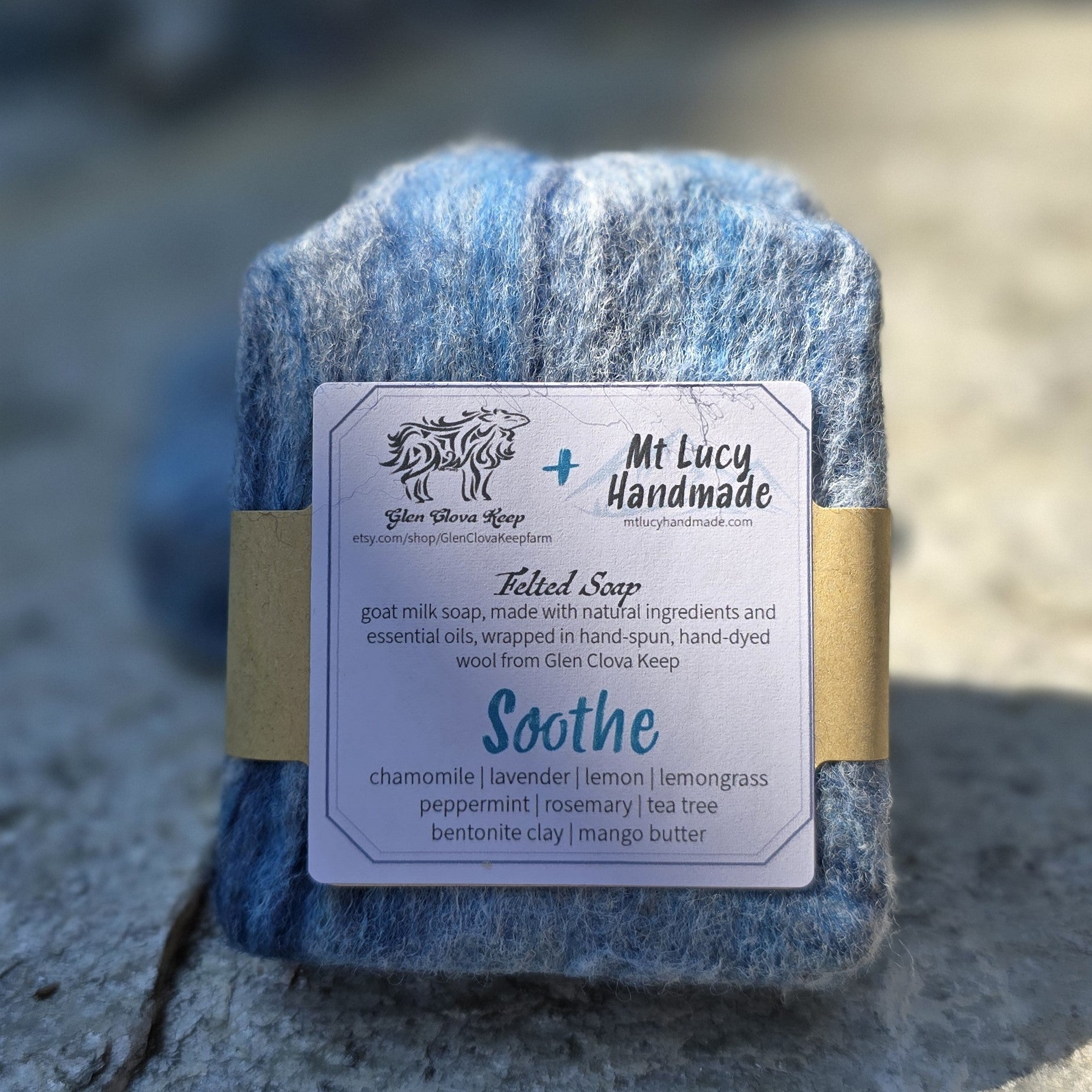 soothe square soap with blue felt and white label on a slate background