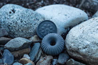 our purify soap variety, donut shape and flower mold, nestled in the rocks